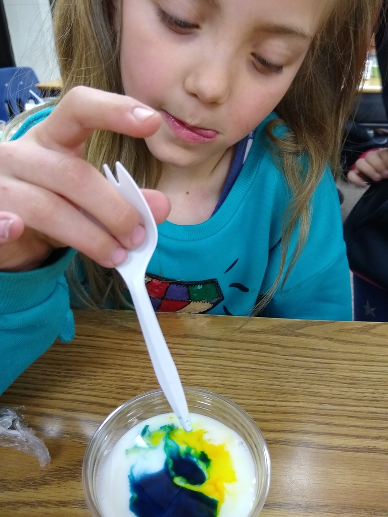 Look what happens when we add blue and yellow food coloring to our milk! 